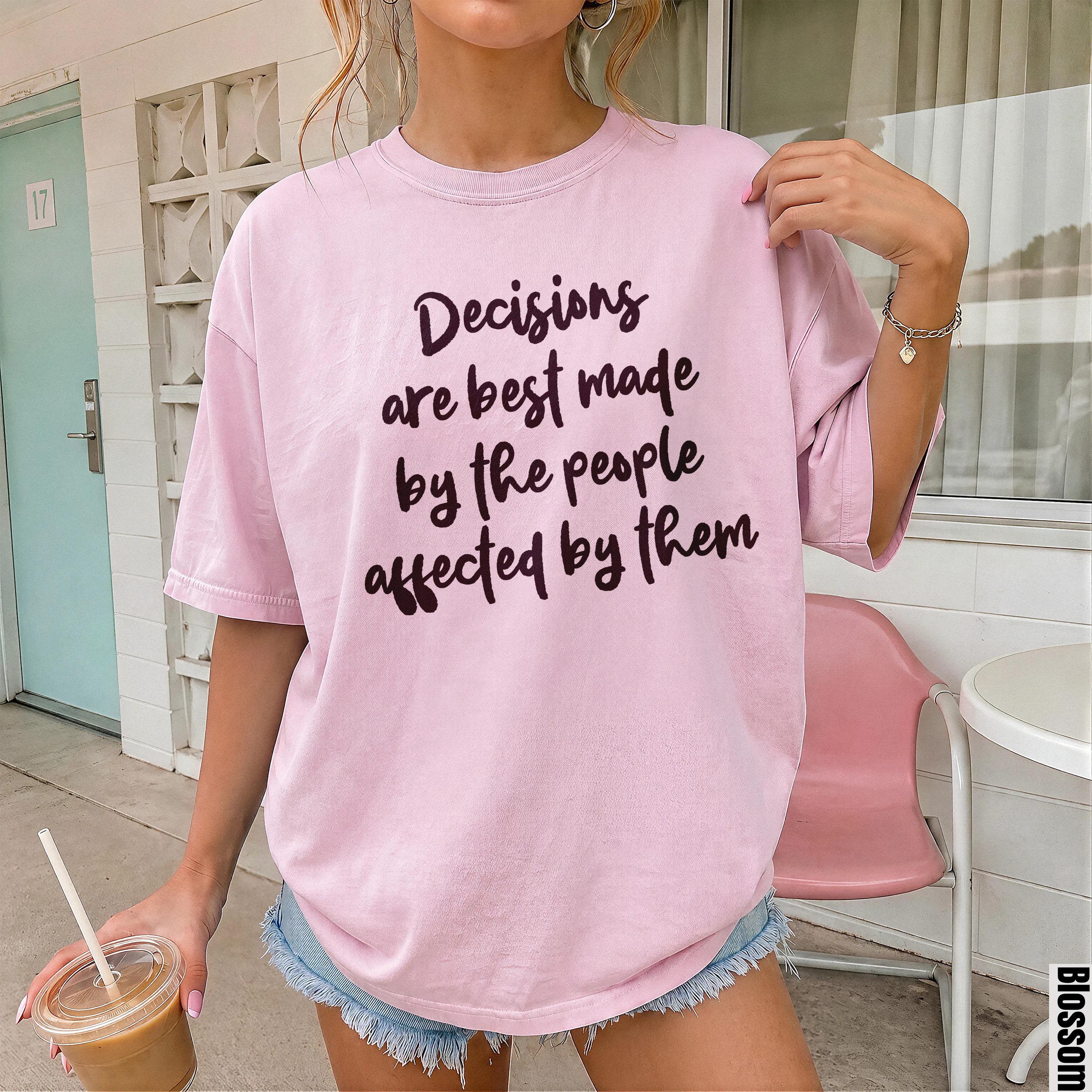 Pink t-shirt with dark purple text &amp;quot;Decisions are best made by the people affected by them.&amp;quot;