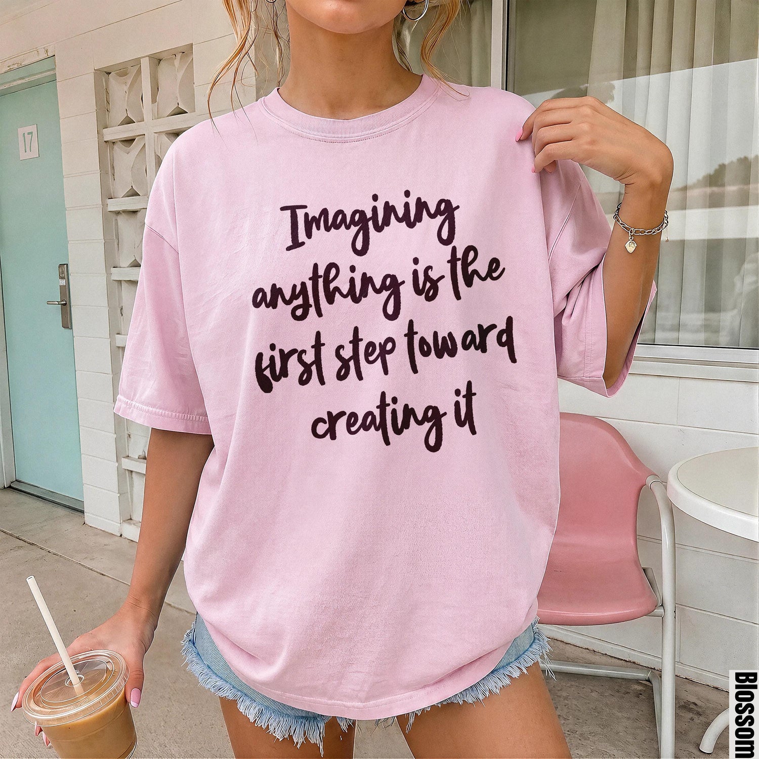 Pink t-shirt with dark text reading &amp;quot;Imagining anything is the first step toward creating it&amp;quot;.