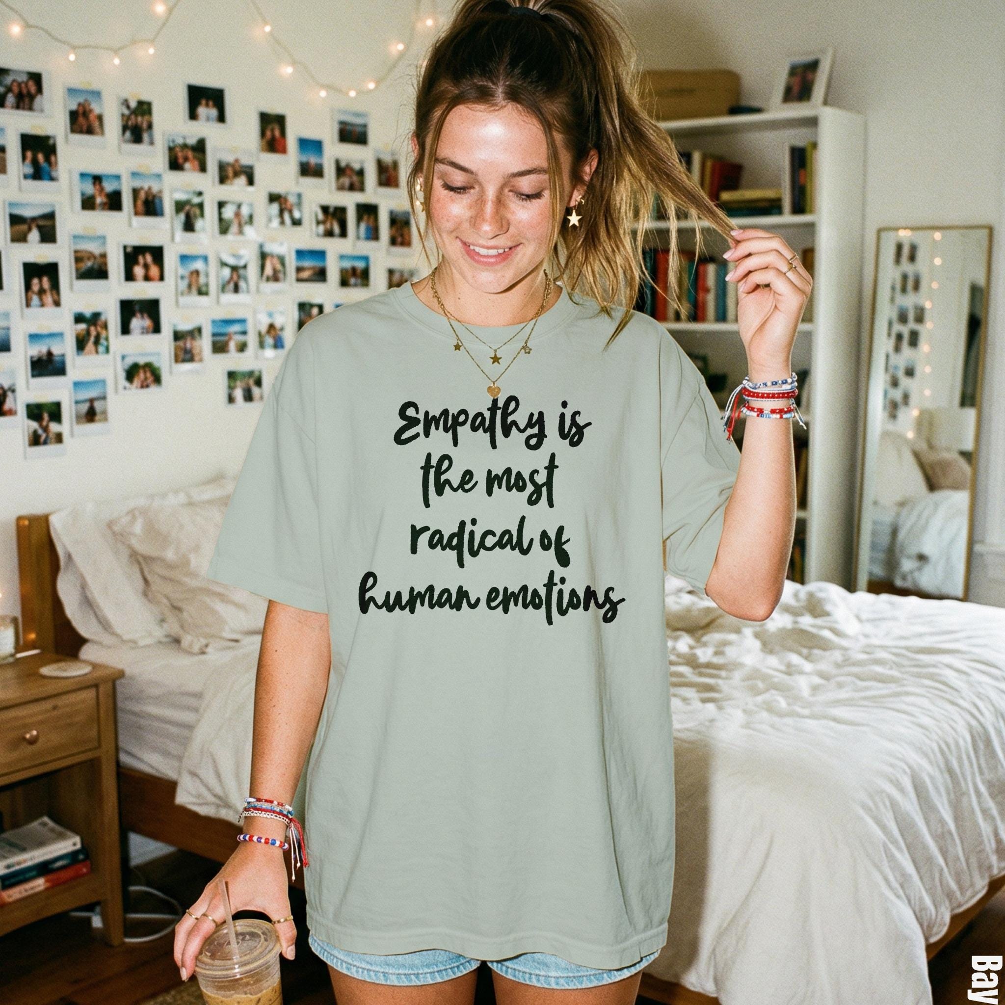 Light green t-shirt with black text &amp;quot;Empathy is the most radical of human emotions&amp;quot;.