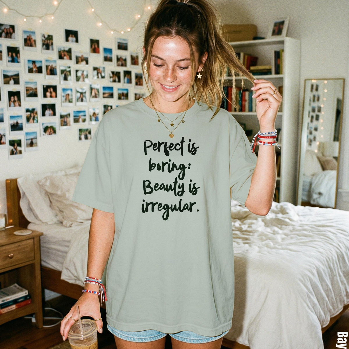 Light green t-shirt with &amp;quot;Perfect is boring: Beauty is irregular.&amp;quot; text.