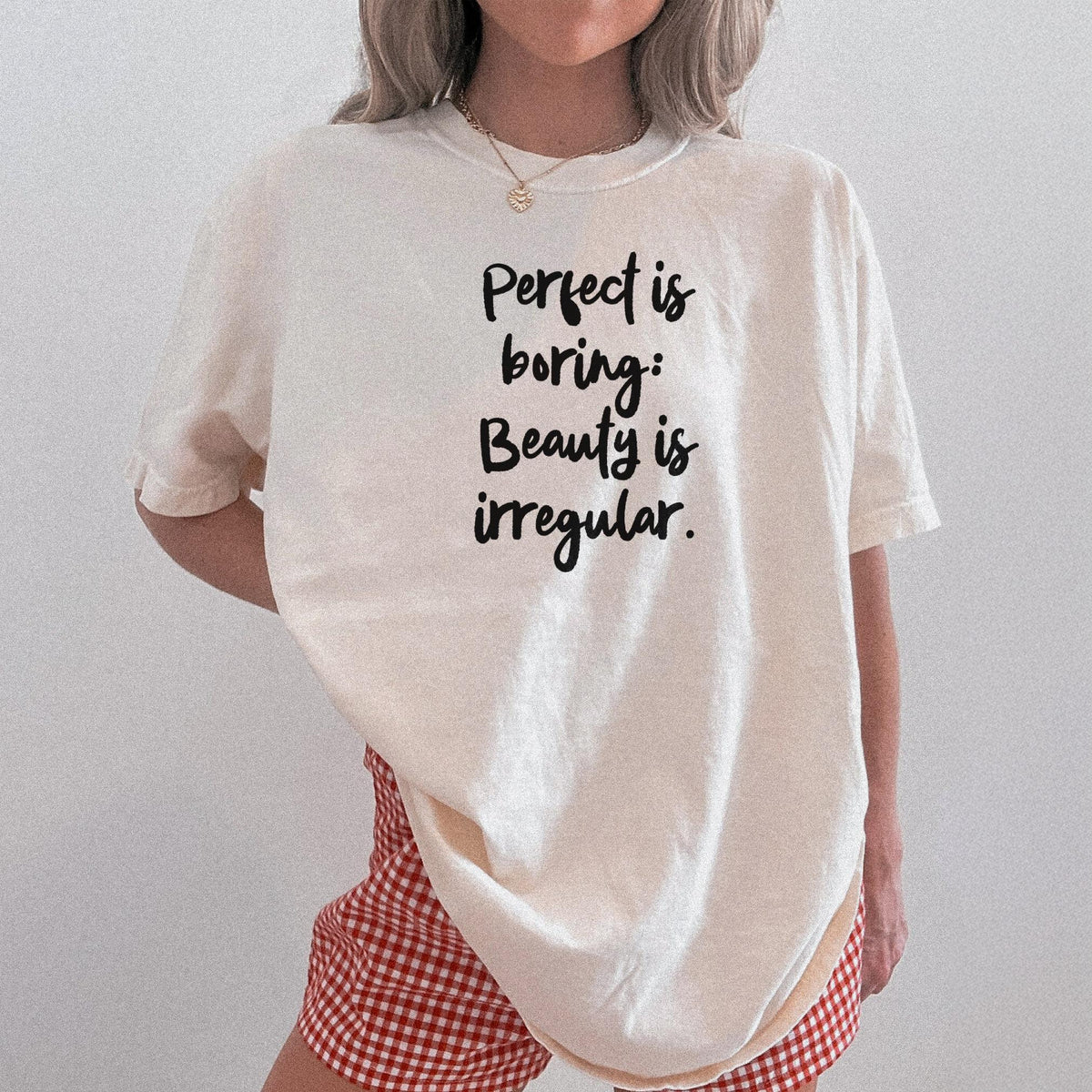 Cream t-shirt with black text &amp;quot;Perfect is boring: Beauty is irregular.&amp;quot;