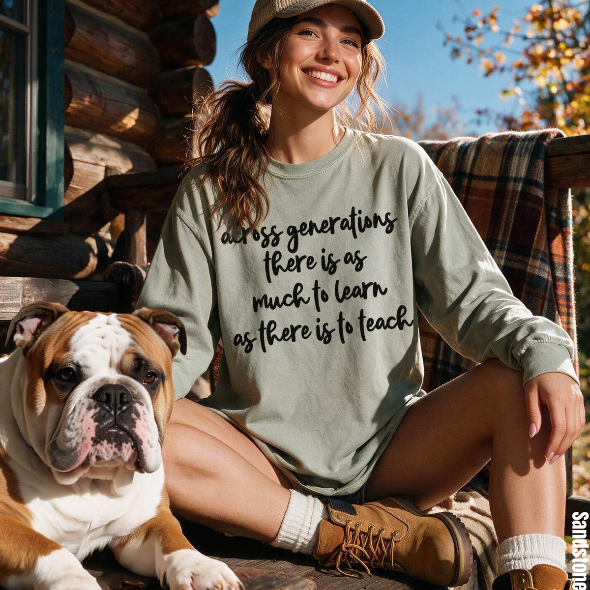 Woman in long-sleeve shirt with &amp;quot;across generations there is as much to learn as there is to teach&amp;quot; text sitting next to bulldog.