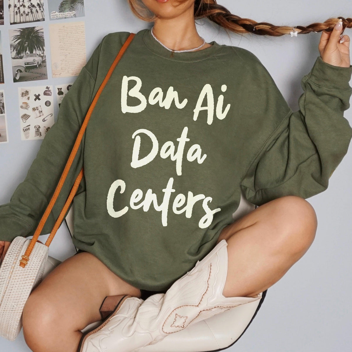 Green sweatshirt with &amp;quot;Ban Ai Data Centers&amp;quot; text, worn by a person.
