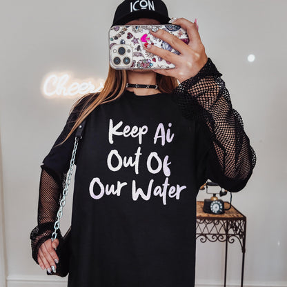 Woman wearing black t-shirt with &amp;quot;Keep Ai Out Of Our Water&amp;quot; text and fishnet sleeves.