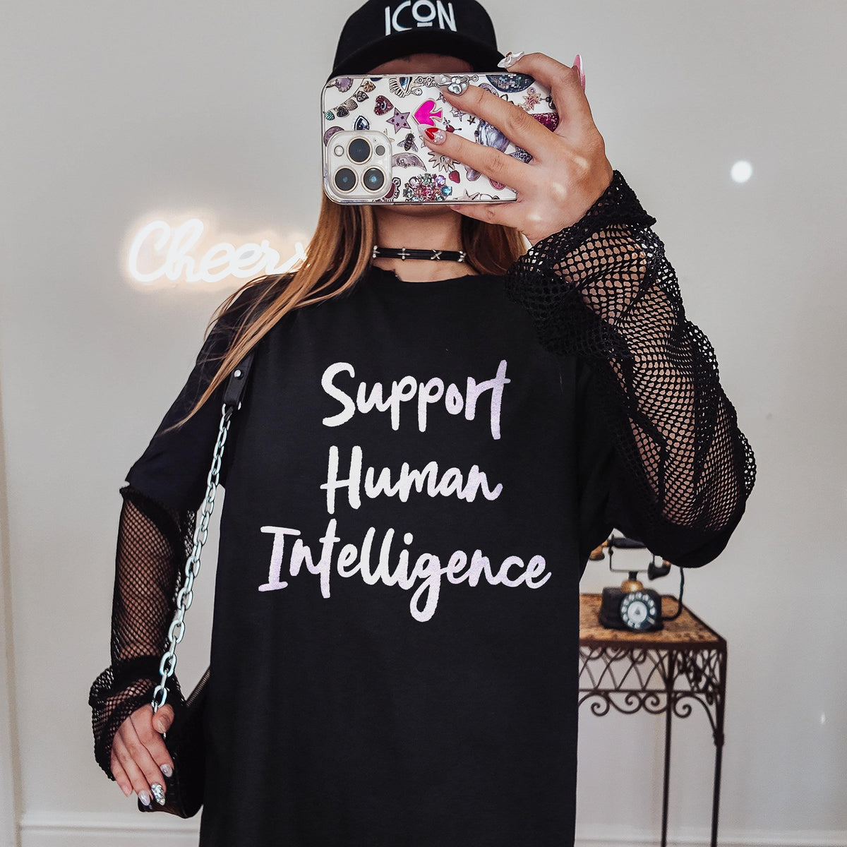 Black t-shirt with &amp;quot;Support Human Intelligence&amp;quot; text, mesh sleeves, and a handbag.