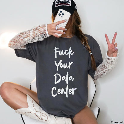 Woman in dark grey t-shirt with white text &amp;quot;Fuck Your Data Center,&amp;quot; white cowboy boots.