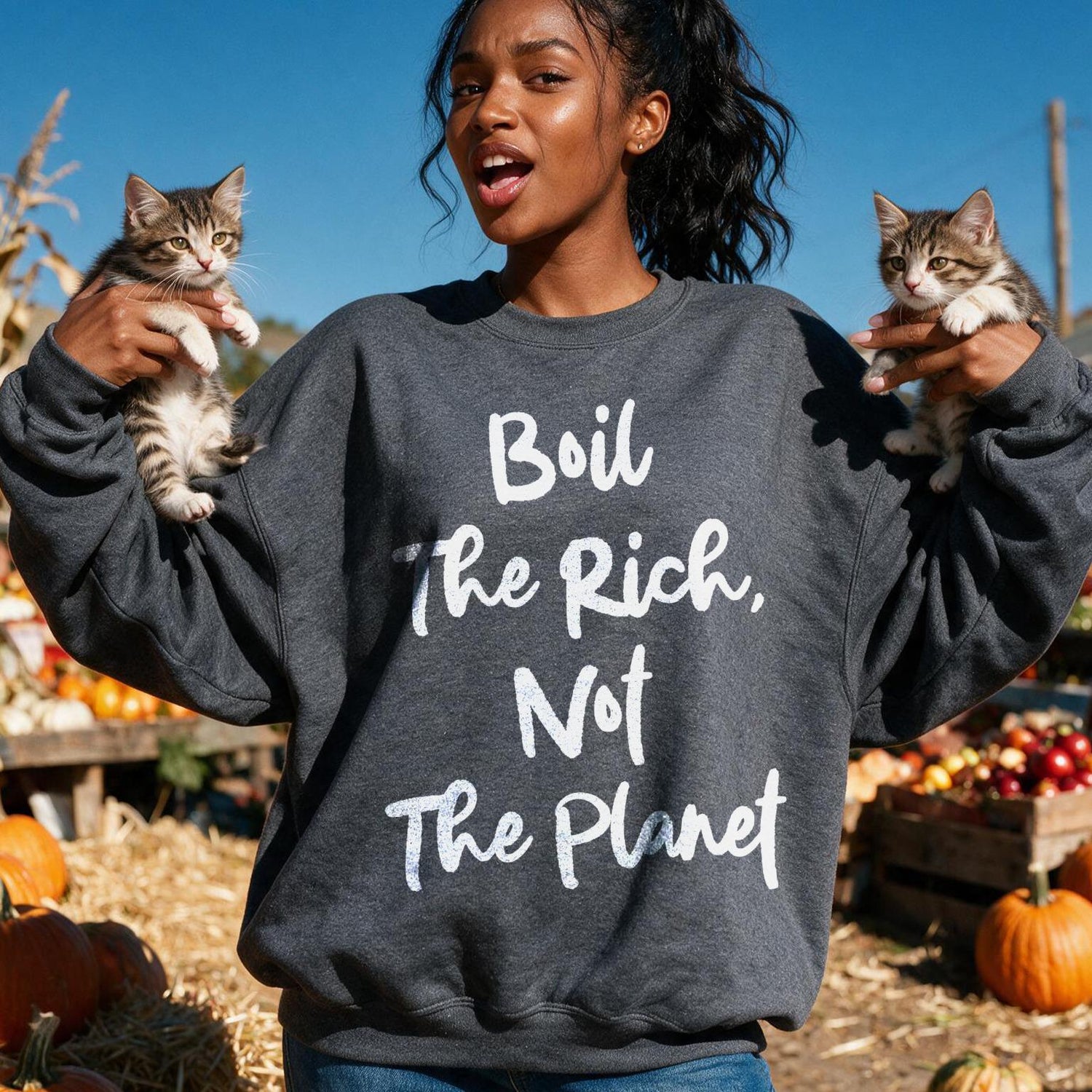 Woman in dark sweatshirt holding two kittens, text reads &amp;quot;Boil the Rich, Not the Planet&amp;quot;.