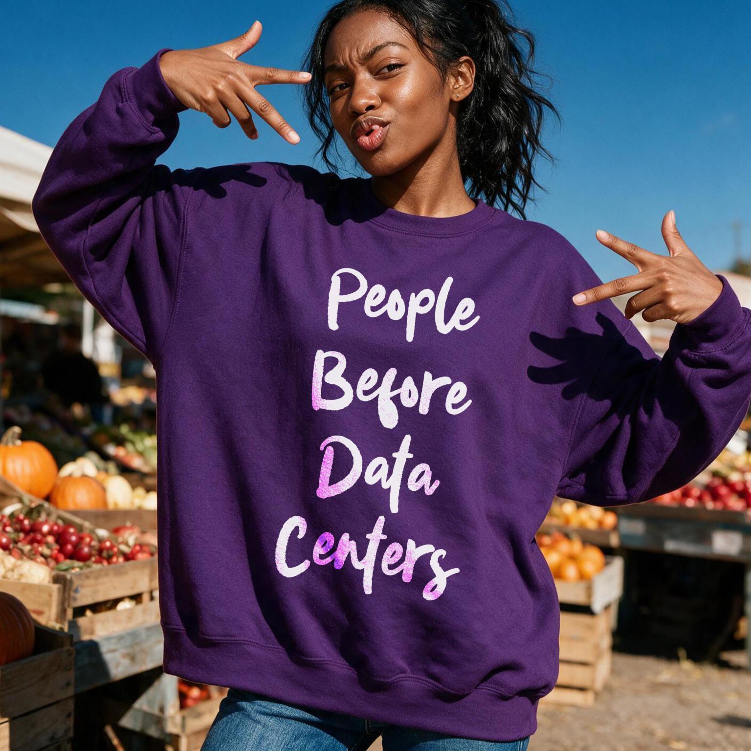 Woman wearing purple sweatshirt with text &amp;quot;People Before Data Centers&amp;quot;.