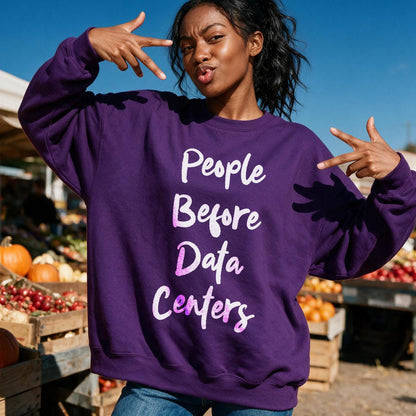 Woman wearing purple sweatshirt with text &amp;quot;People Before Data Centers&amp;quot;.