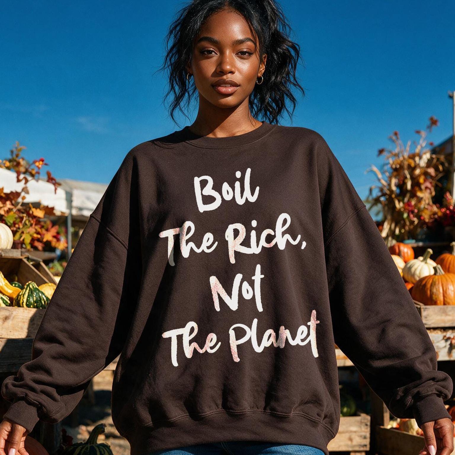 Brown sweatshirt with white text &amp;quot;Boil The Rich, Not The Planet&amp;quot; on a woman.