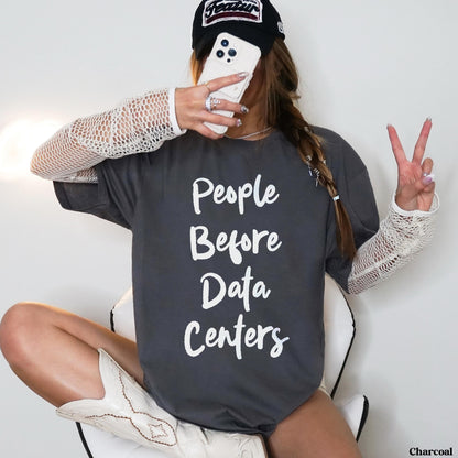 Charcoal t-shirt with &amp;quot;People Before Data Centers&amp;quot; text, held phone, and peace sign.