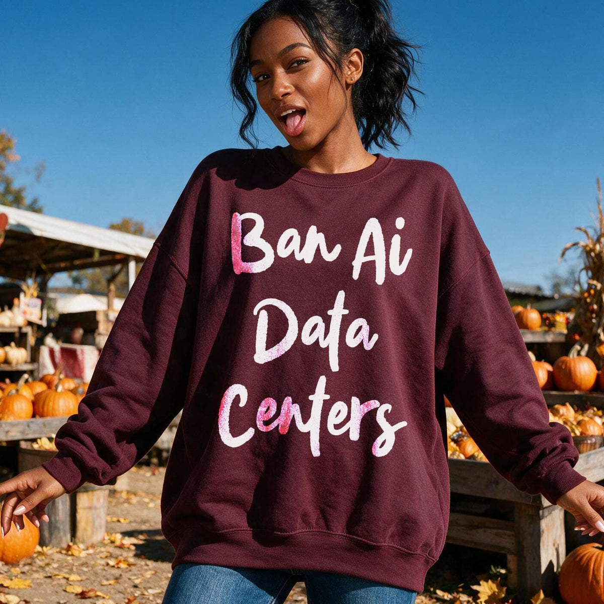 Maroon sweatshirt with white text &amp;quot;Ban Ai Data Centers&amp;quot; on a pumpkin patch background.