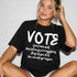 Black t-shirt with "VOTE" and registration message.