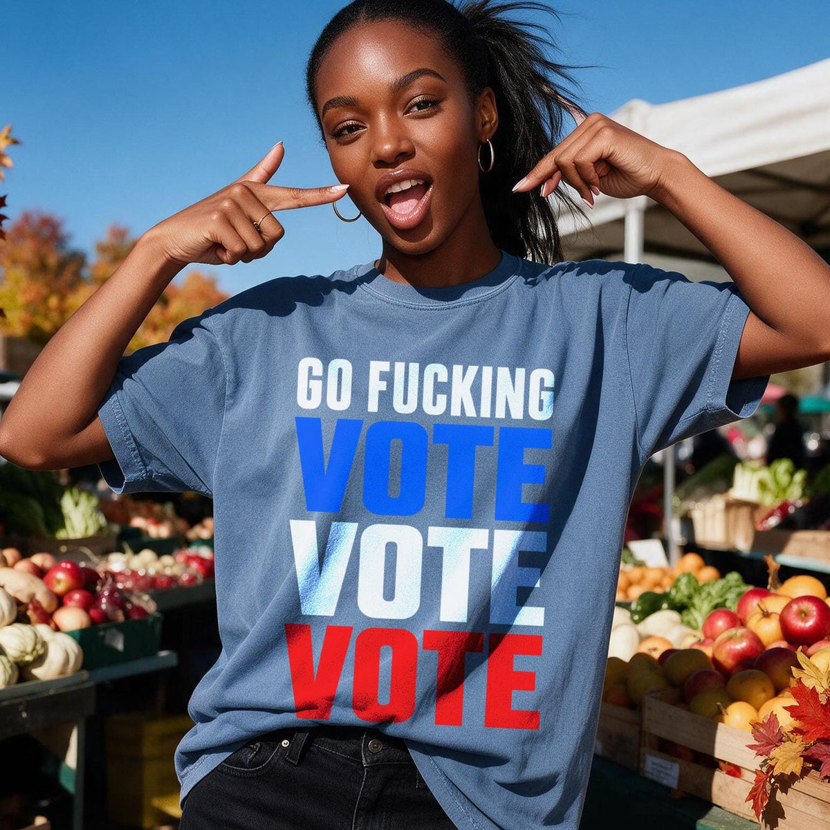 Woman points to shirt with &amp;quot;GO FUCKING VOTE&amp;quot; in blue, white, and red.