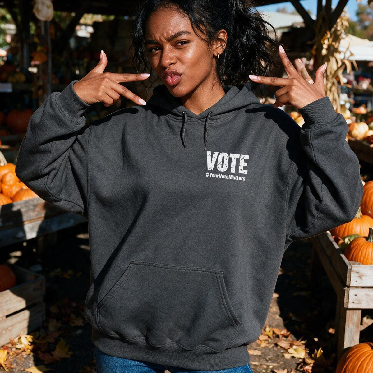 Woman wearing dark grey hoodie with white &amp;quot;VOTE 