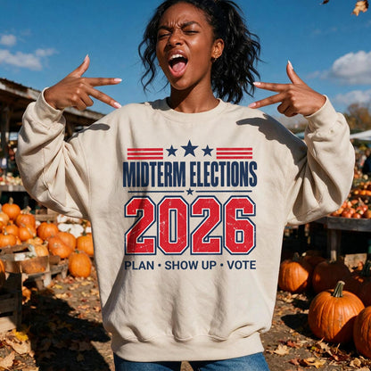 Light tan sweatshirt with &amp;quot;Midterm Elections 2026&amp;quot; and &amp;quot;Plan, Show Up, Vote&amp;quot;.