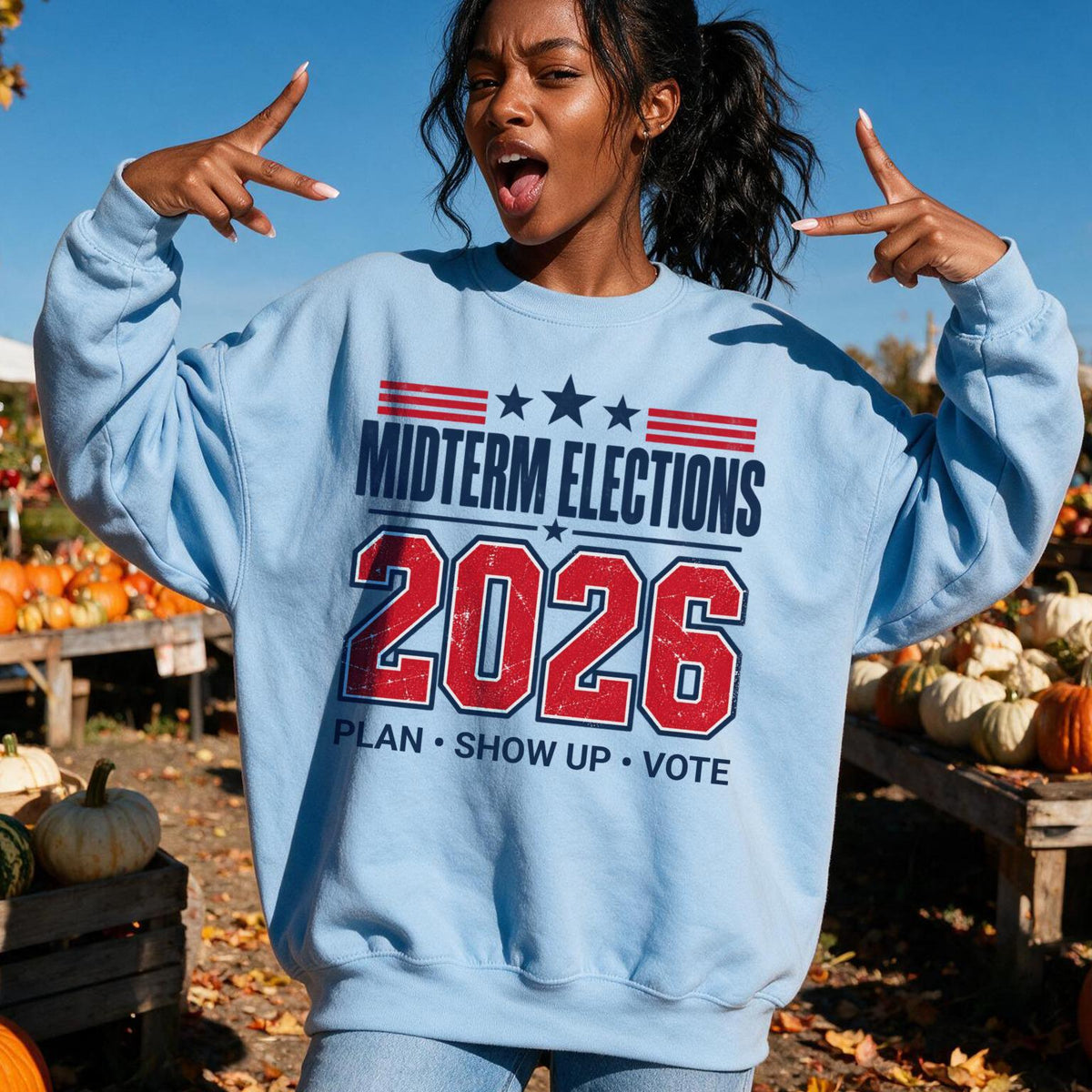Light blue sweatshirt with &amp;quot;Midterm Elections 2026 Plan Show Up Vote&amp;quot; text.