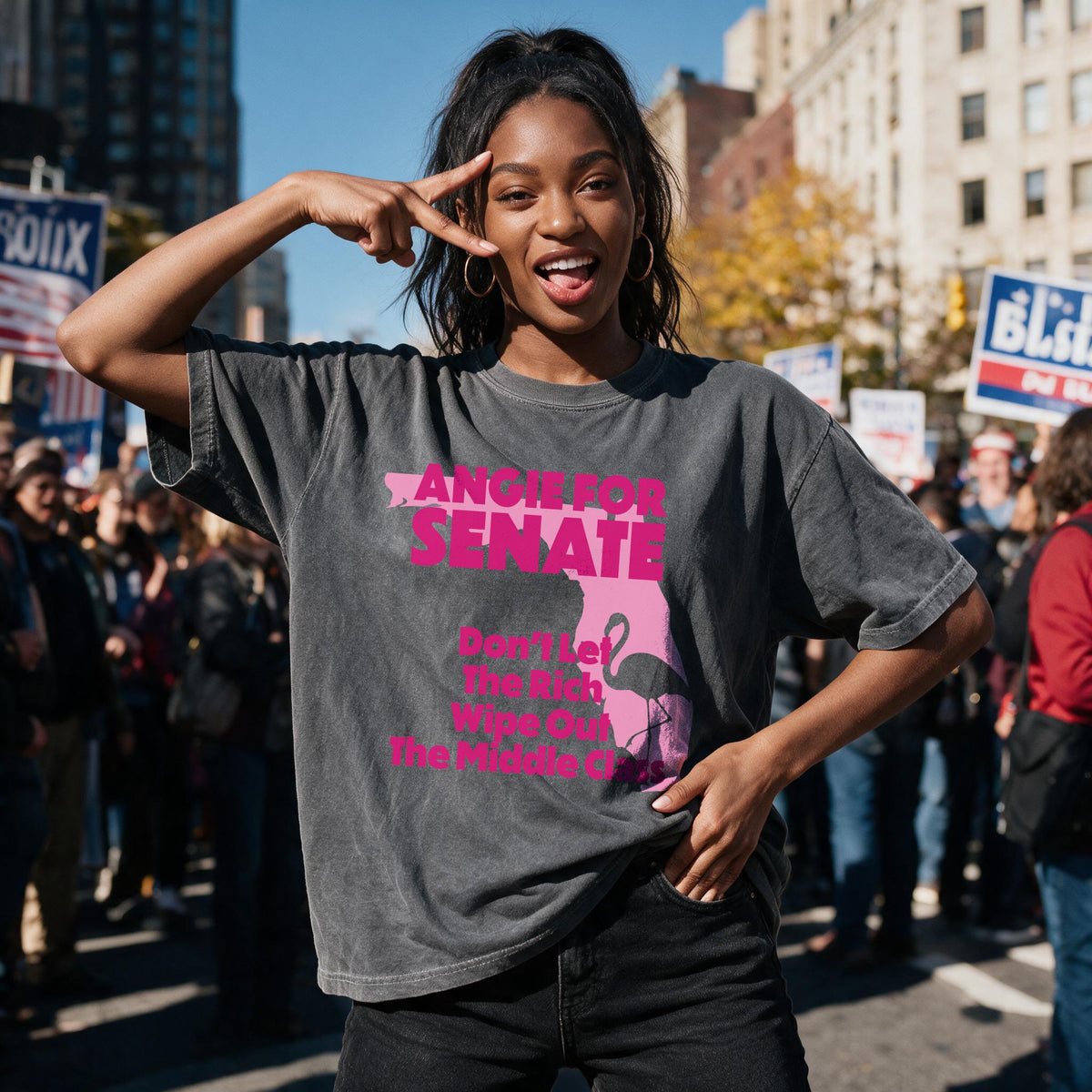 Woman wearing grey t-shirt with pink text &amp;quot;Angie for Senate&amp;quot; and flamingo graphic.
