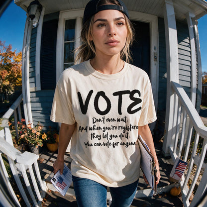 Woman in VOTE shirt stands on porch with election materials.