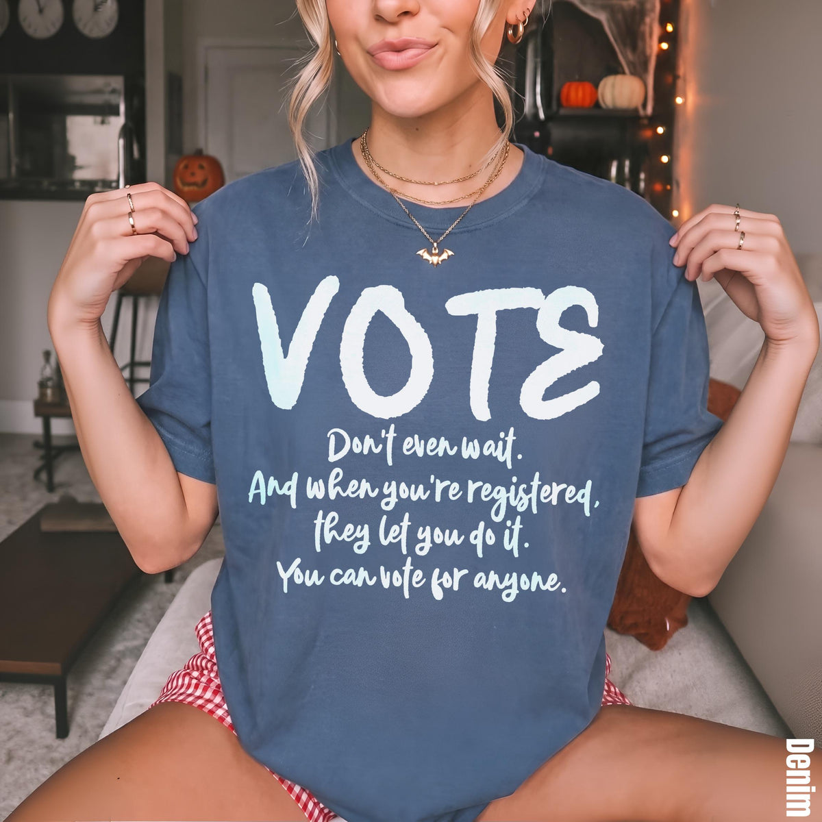 Blue t-shirt with white text &amp;quot;VOTE&amp;quot; and voting-related phrases.
