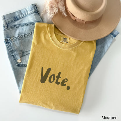 Mustard t-shirt with &amp;quot;Vote.&amp;quot; graphic, jeans, and hat.