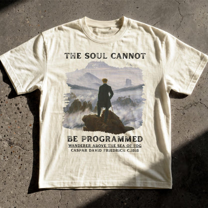 White t-shirt with &amp;quot;The Soul Cannot Be Programmed&amp;quot; and artwork.