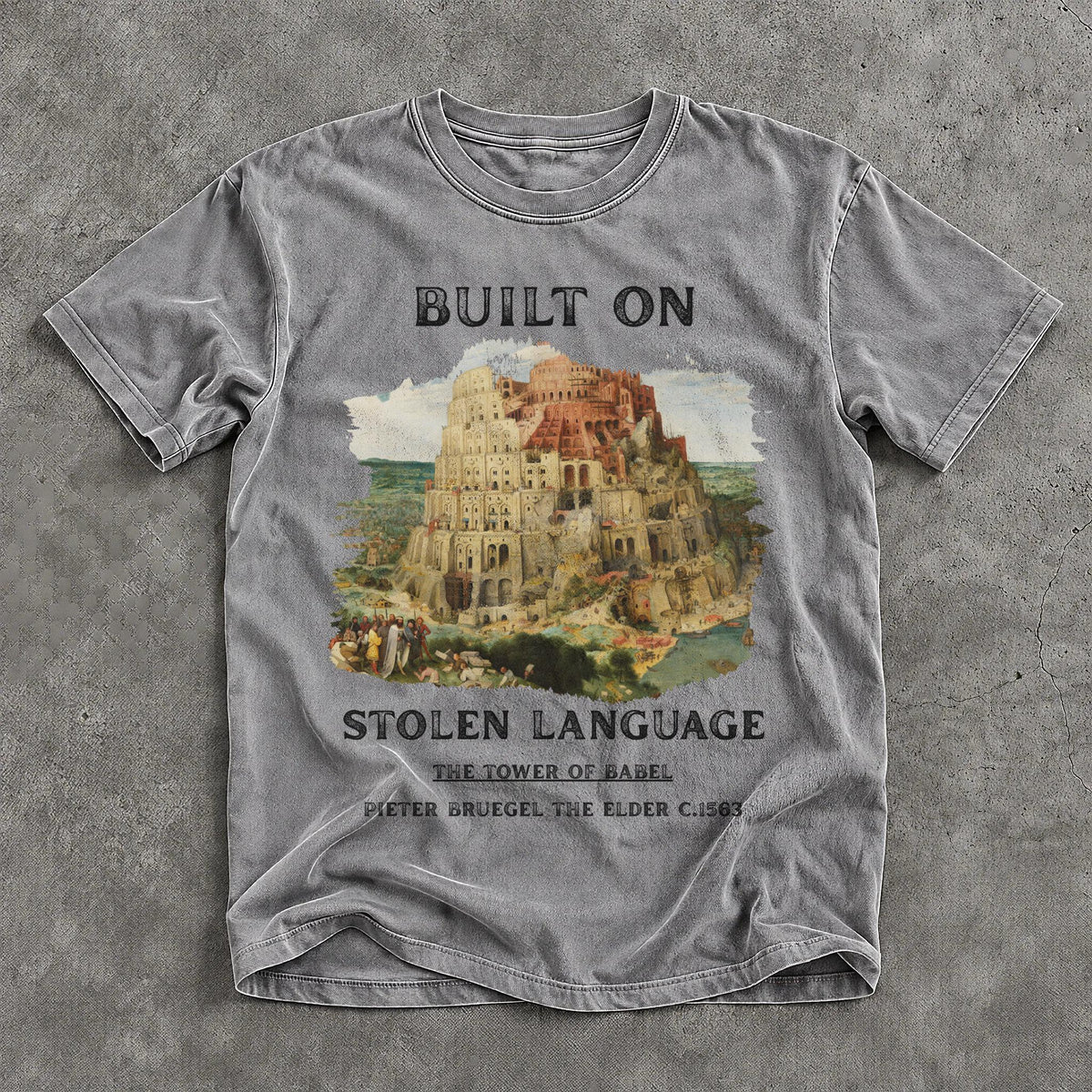 Grey t-shirt with &amp;quot;BUILT ON STOLEN LANGUAGE&amp;quot; and Tower of Babel artwork.