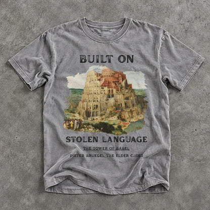 Grey t-shirt with &amp;quot;BUILT ON STOLEN LANGUAGE&amp;quot; and Tower of Babel artwork.