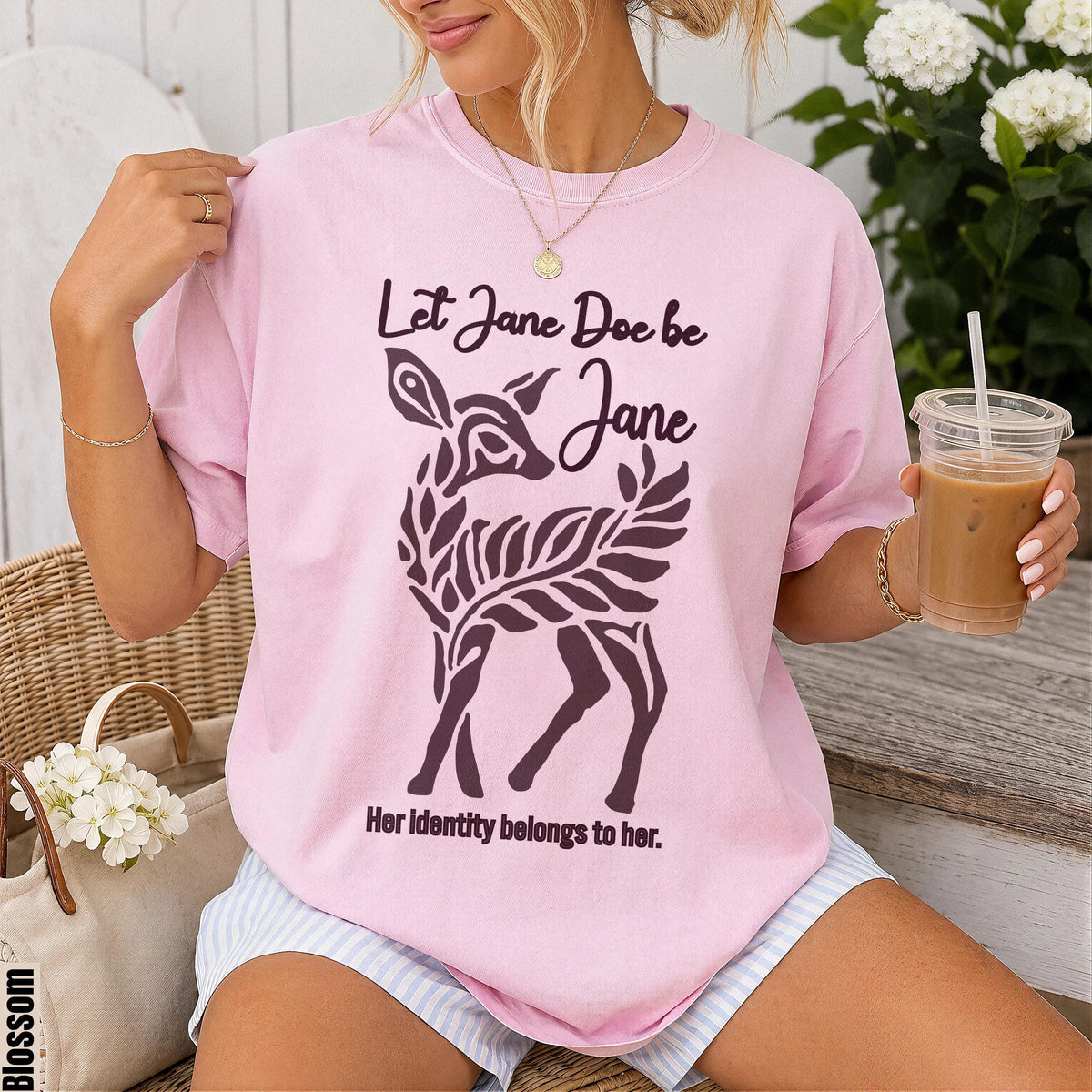 Pink t-shirt with a dark graphic of a deer and text &amp;quot;Let Jane Doe be Jane. Her identity belongs to her.&amp;quot;