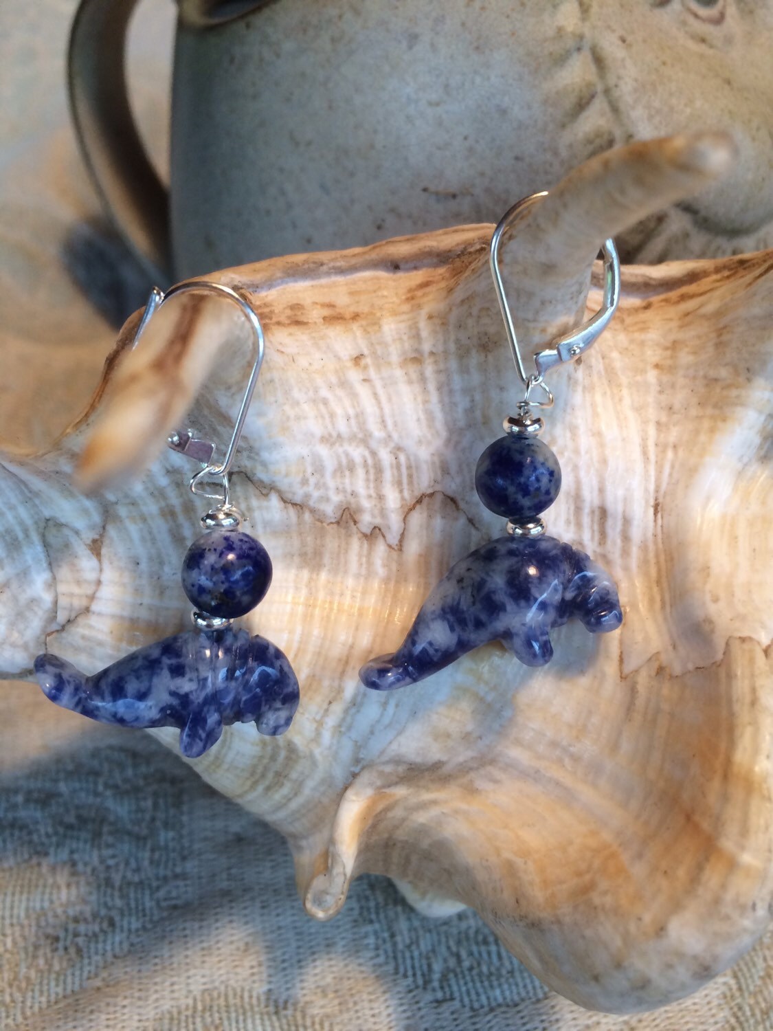 Lifestyle image of Manatee Earrings - Blue sodalite earrings on display, embodying ocean lover jewelry with charming animal motifs.