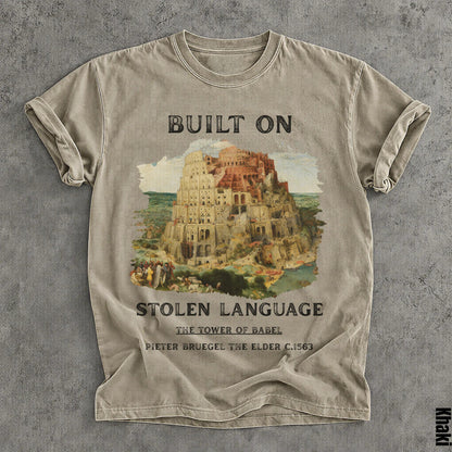 T-shirt with &amp;quot;BUILT ON STOLEN LANGUAGE&amp;quot; and Tower of Babel artwork by Pieter Bruegel.