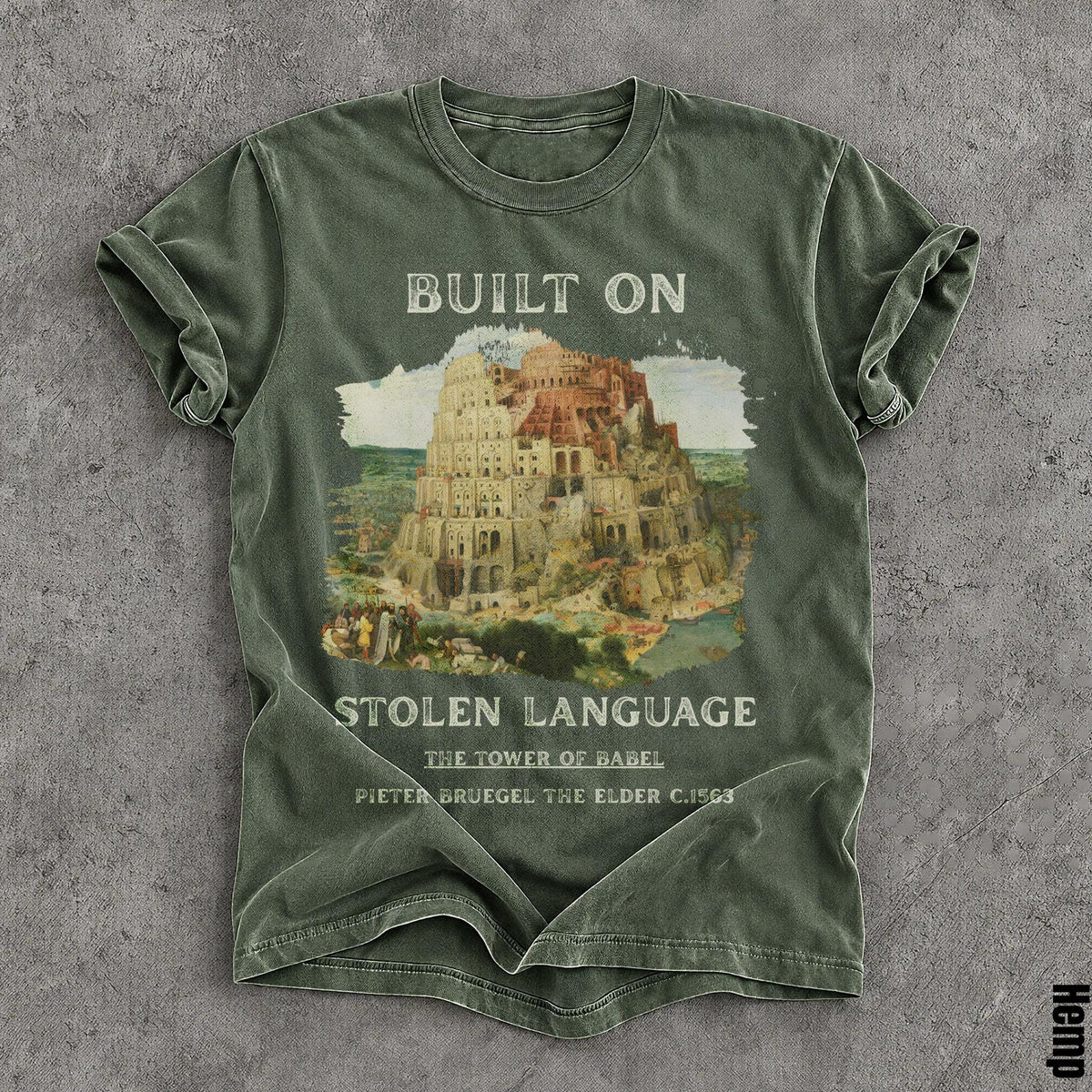 Green t-shirt with &amp;quot;BUILT ON STOLEN LANGUAGE&amp;quot; and Tower of Babel artwork.