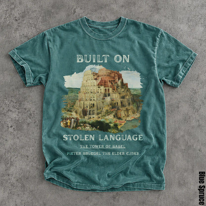 Blue t-shirt with &amp;quot;Built on Stolen Language&amp;quot; and The Tower of Babel art.
