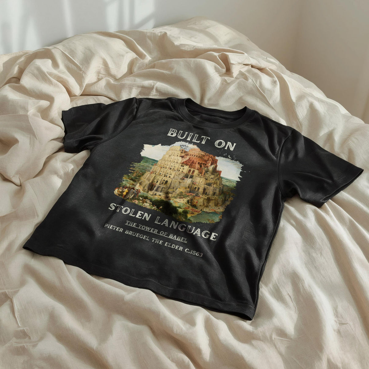 Black t-shirt with &amp;quot;Built On Stolen Language&amp;quot; and &amp;quot;The Tower of Babel&amp;quot; by Pieter Bruegel the Elder.