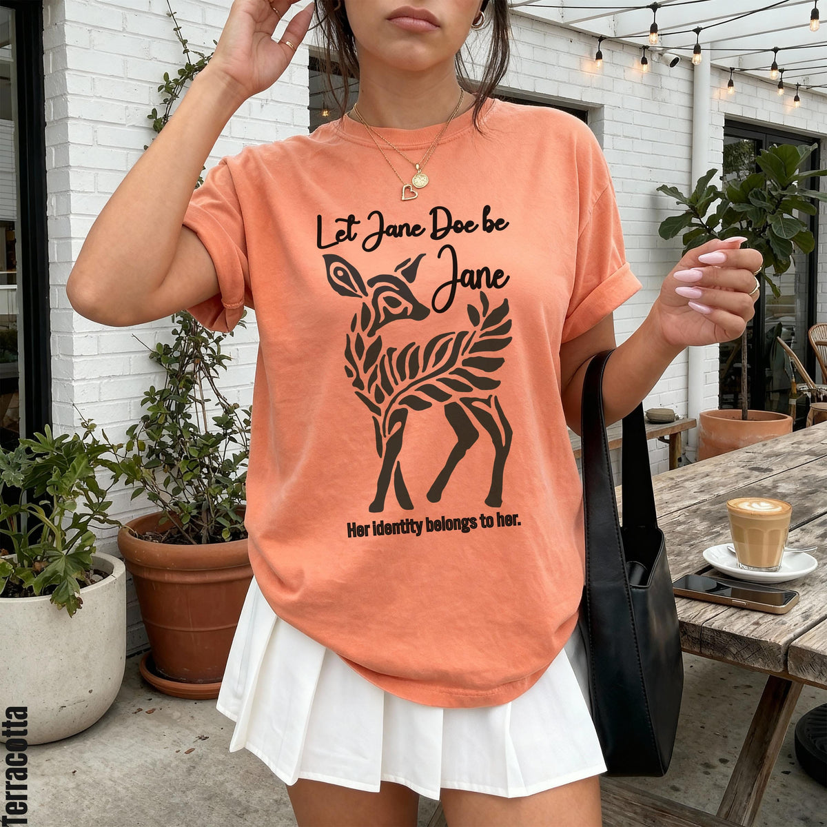 Terracotta t-shirt with deer graphic and text &amp;quot;Let Jane Doe be Jane&amp;quot;.