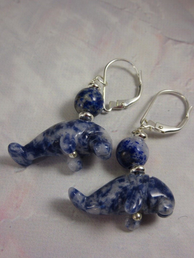 Close-up of Manatee Earrings - Blue sodalite lever back earrings, featuring unique swirls of white and blue, ideal as a cute animal gift.