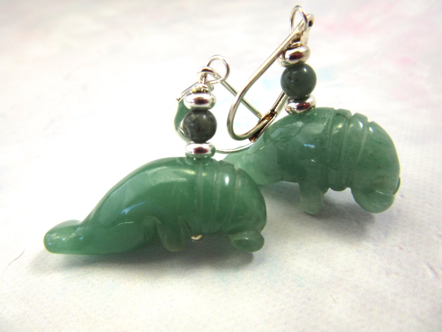 Close-up of Aventurine Carved Stone Manatee Earrings, showcasing the intricate craftsmanship and vibrant green color, ideal gift for animal lovers.