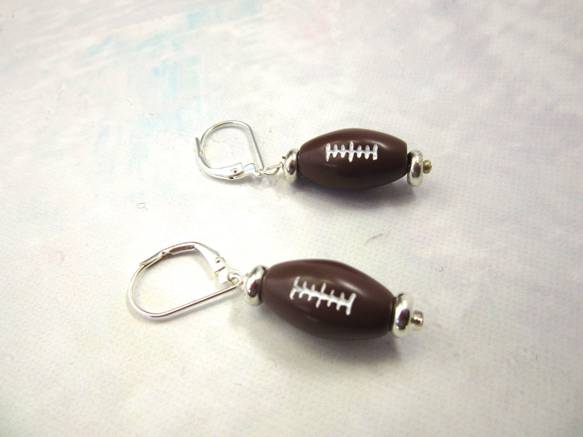 A pair of Football Novelty Earrings, handmade with sterling silver ear wires, ideal gifts for moms or coaches in youth football.