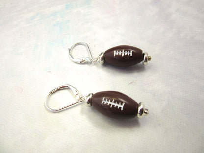 A pair of Football Novelty Earrings, handmade with sterling silver ear wires, ideal gifts for moms or coaches in youth football.