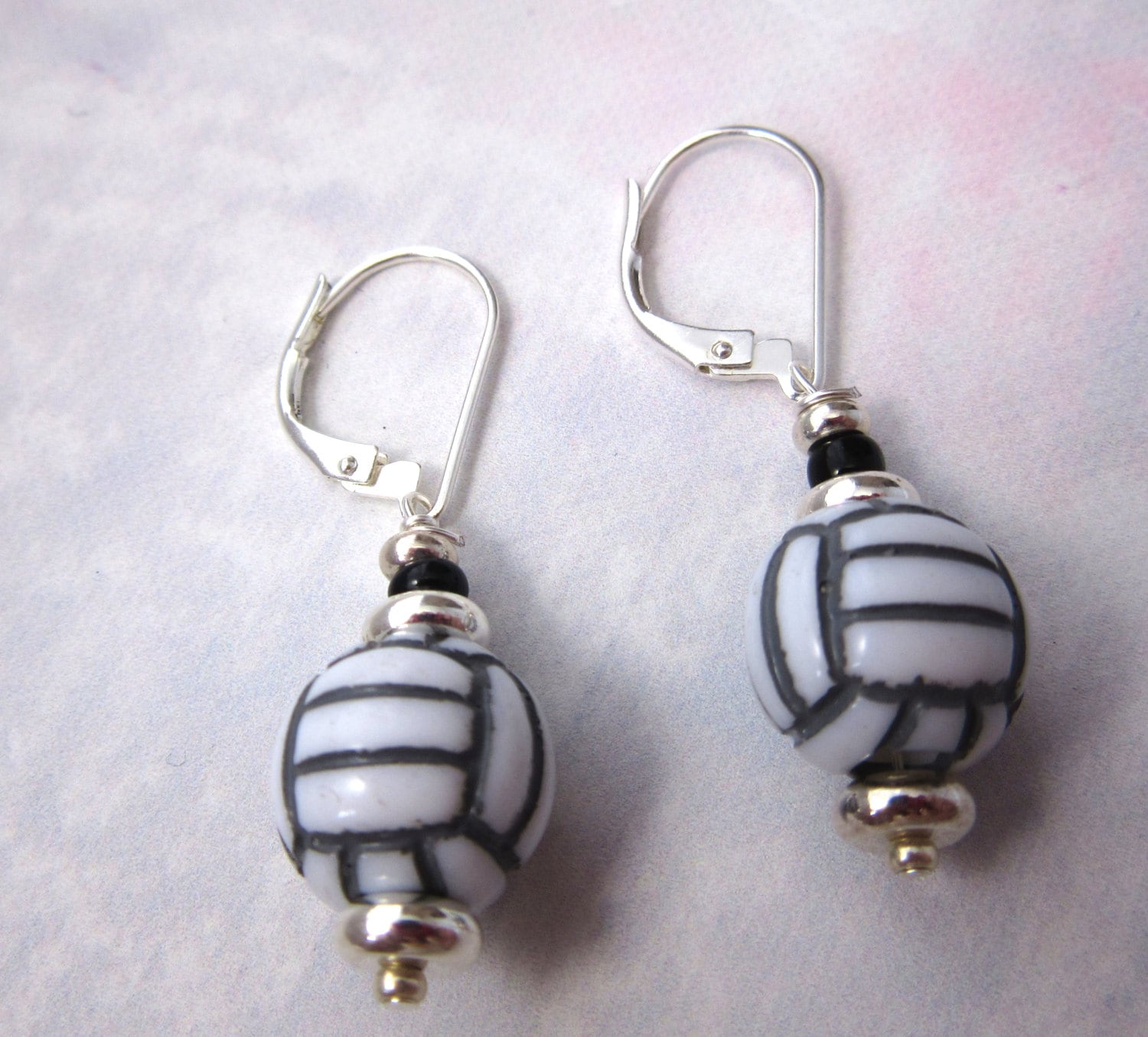 Volleyball earrings - Sport Ball Jewelry displayed against a vibrant background, an ideal gift for volleyball enthusiasts.