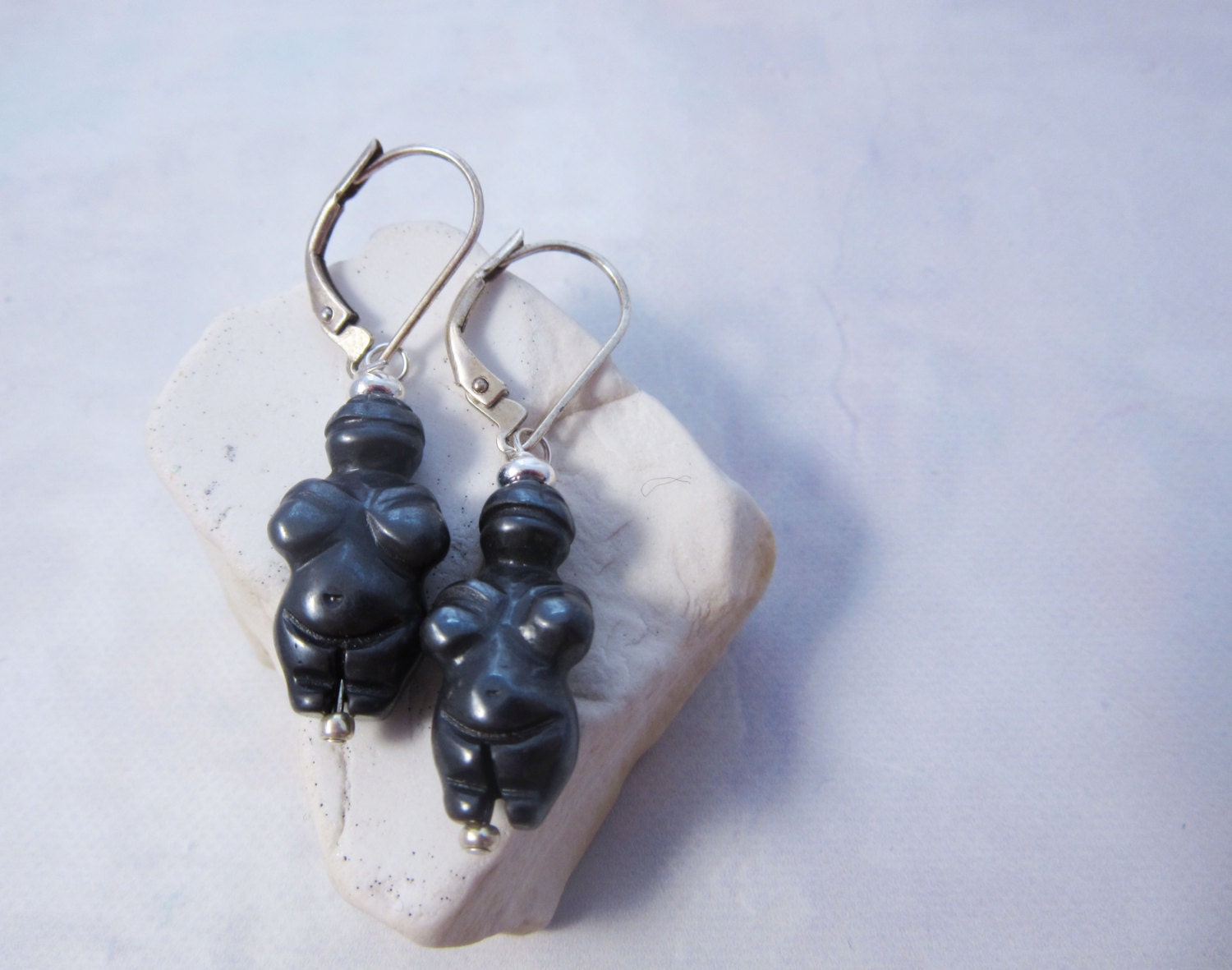 Close-up of Goddess earrings- Venus of Willendorf, highlighting the intricate detail of the carved stone high priestess.