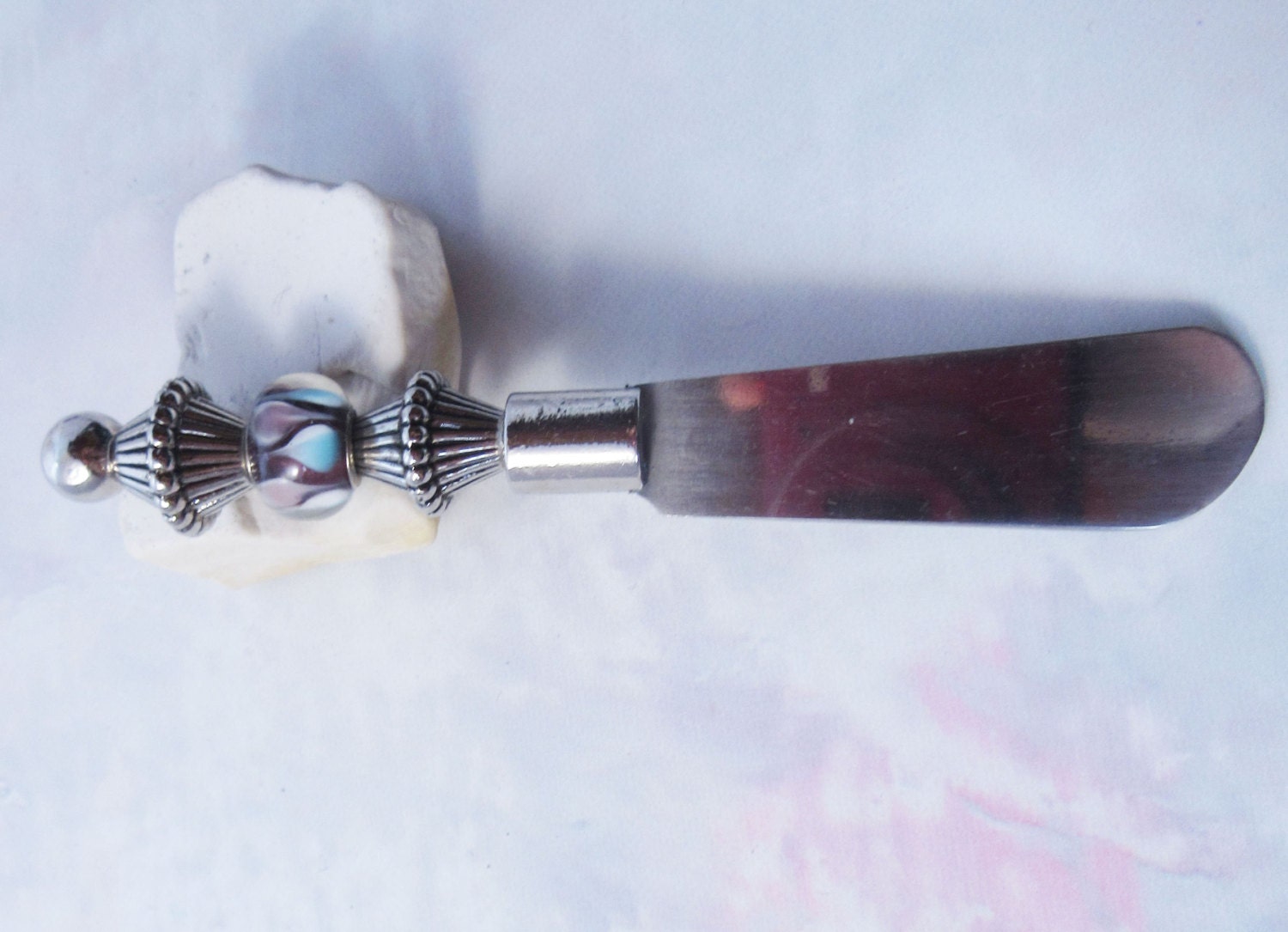 Close-up of Dip Spreader Knife - Glass Beads Handle, highlighting the intricate bead design and shiny silver finish perfect for hosting.