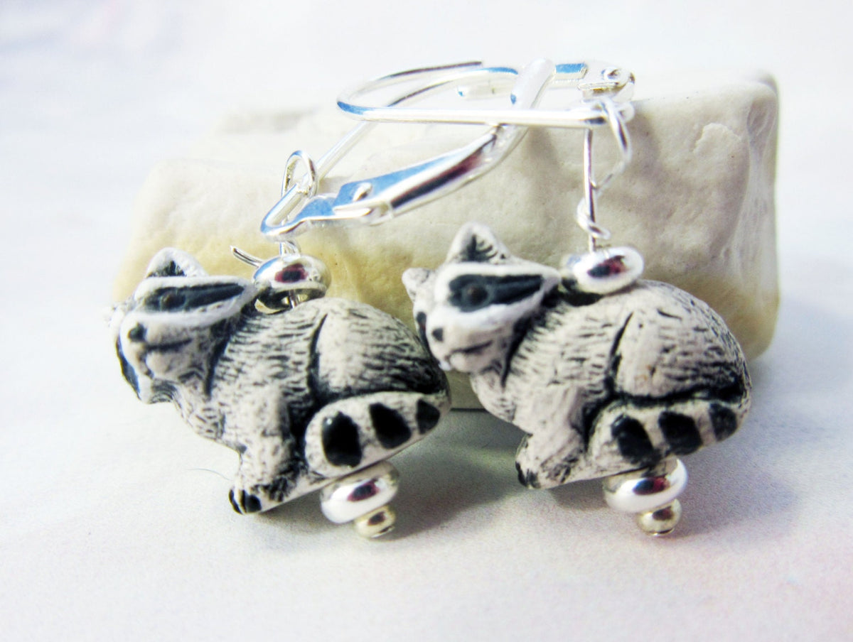 RACCOON EARRINGS featuring hematite stone, a cute woodland animal design suitable for nature lovers, showcasing hand-painted details and boho style.