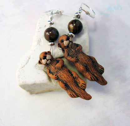 Close-up of Otter Earrings - Sea Otter Jewelry showcasing intricate hand painted details and sterling silver backs.