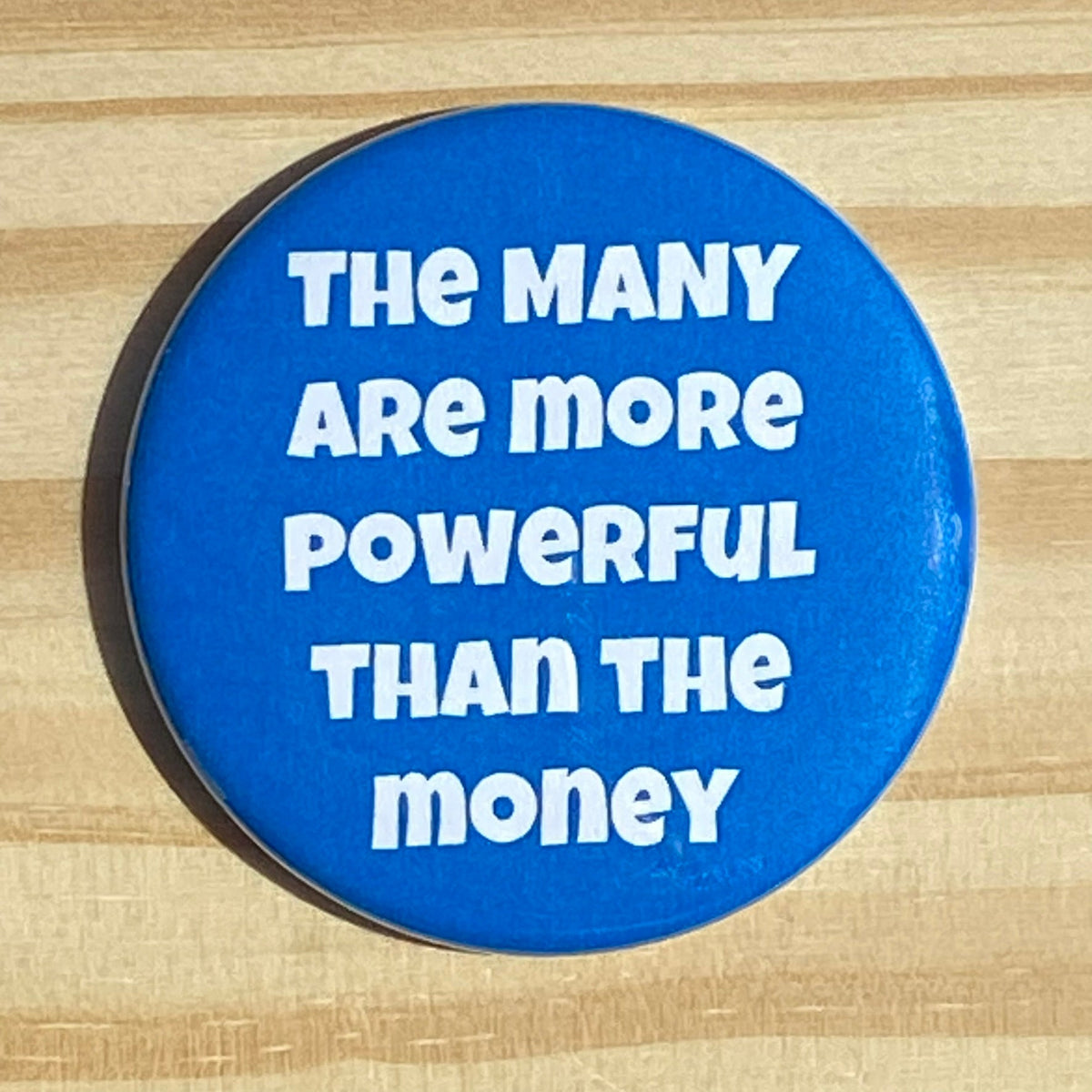 The many are more powerful than the money - button/magnet/mirror
