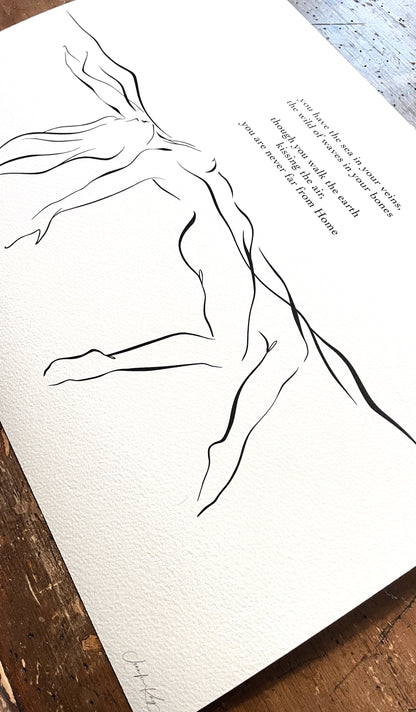 Black and white elegant line art illustration of sensual woman floating in water; fine art print on slightly textured Aquarelle Rag paper lays on wooden desk.