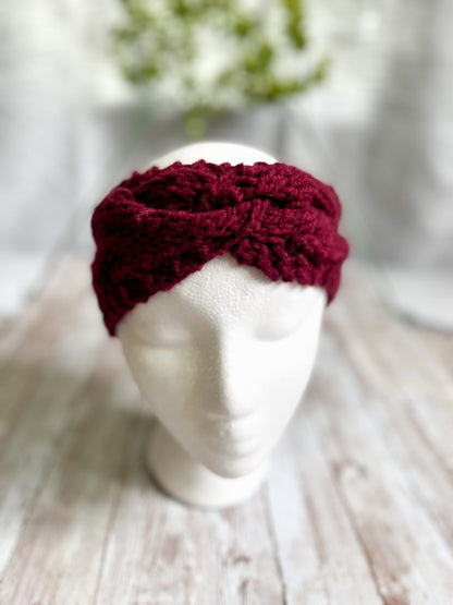 A mannequin head displays a red hand-dyed, Virginia-raised merino cabled ear warmer