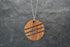 Round wood and stone inlay pendant in Walnut with crushed Lapis Lazuli, sterling silver chain
