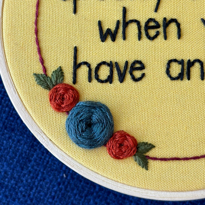 Embroidery hoop reads, "It&