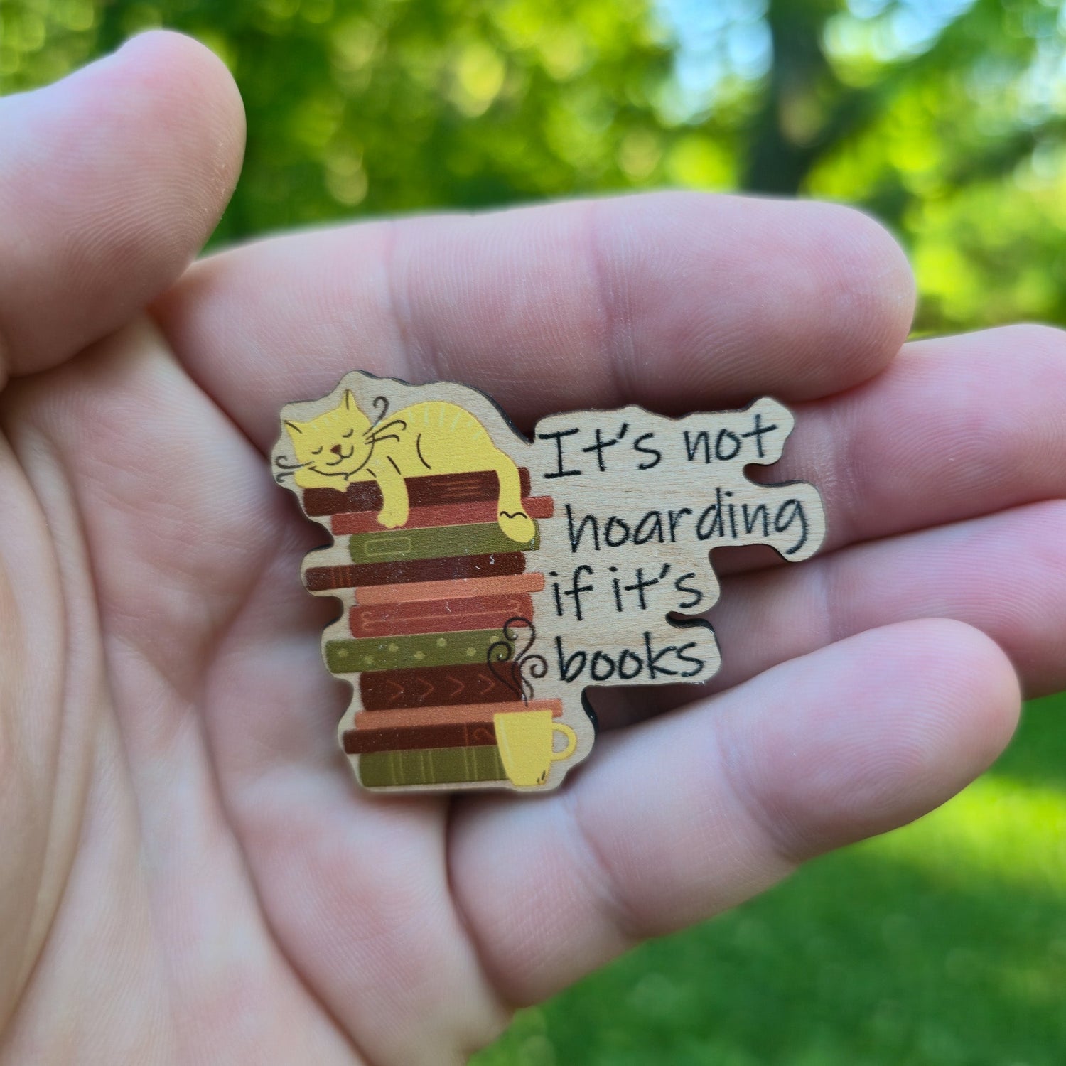 Wooden magnet with a cat on books design and text &